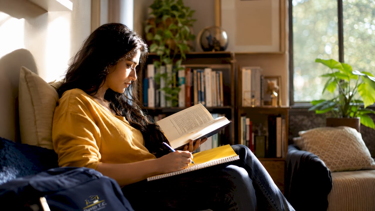 Woman reading book to improve writing skills